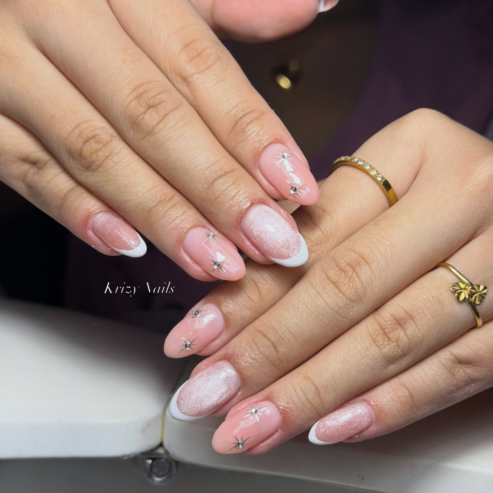Pearl Bow Française nail design — Soft pink base with glitter accents, bows and crystal studs.