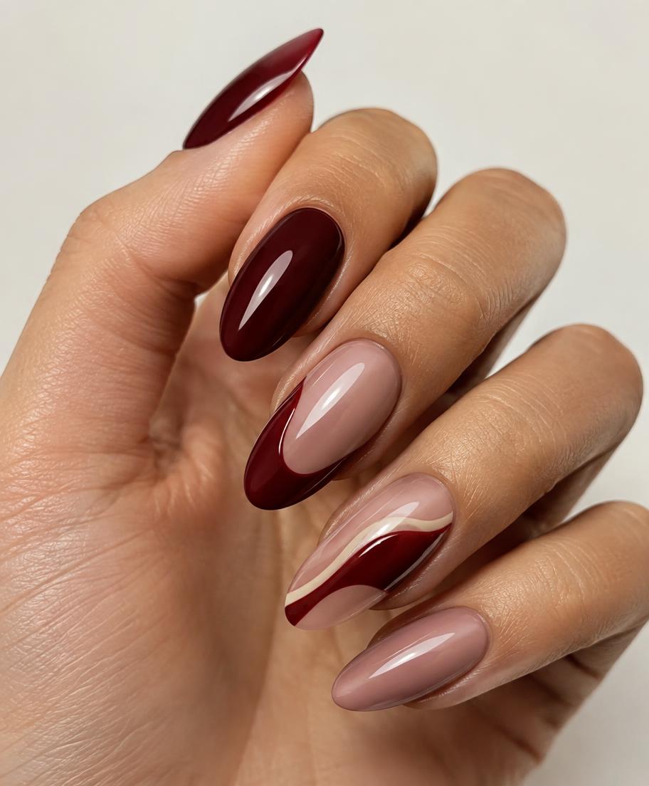Burgundy Swirl nail design — Deep burgundy swirls over a dusty rose base.